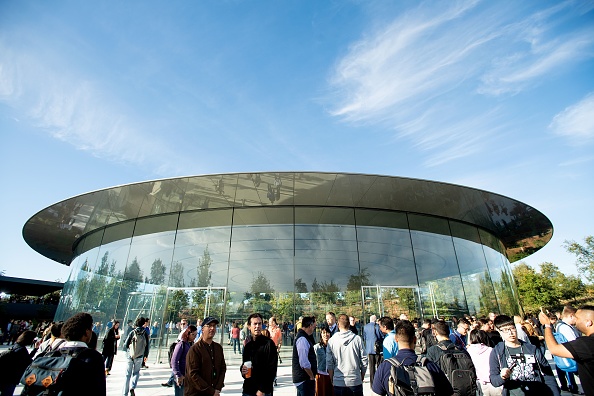 Attendees gather for a product launch event at Apple's Steve Jobs Theater on September 12, 2018, in Cupertino, California. - New iPhones set to be unveiled Wednesday offer Apple a chance for fresh momentum in a sputtering smartphone market as the California tech giant moves into new products and services to diversify.Apple was expected to introduce three new iPhone models at its media event at its Cupertino campus, notably seeking to strengthen its position in the premium smartphone market a year after launching its $1,000 iPhone X. (Photo by NOAH BERGER / AFP)        (Photo credit should read NOAH BERGER/AFP/Getty Images)
