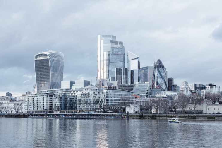 modern skyscrapers near calm river