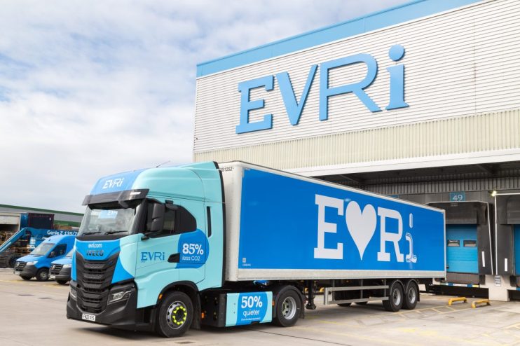 Liveried Evri vehicles by a distribution centre. Credit: Evri/PA