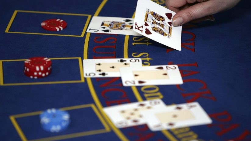 BLACKPOOL, UNITED KINGDOM - FEBRUARY 17: A croupier deals cards on a Black Jack table on February 17, 2006, Blackpool, England. Blackpool and The Fylde College has become the first educational establishment in Britain to offer training and qualifications in gaming. The gaming academy came into existence after changes in the Uk gaming laws and created a skills gap in the industry. Students are trained in every aspect in a casino form running card tables to servicing slot machines. (Photo by Christopher Furlong/Getty Images)