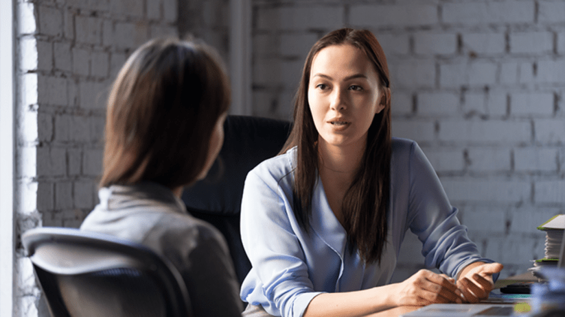 Ambitious professional discussing MBA sponsorship with employer in a modern office setting