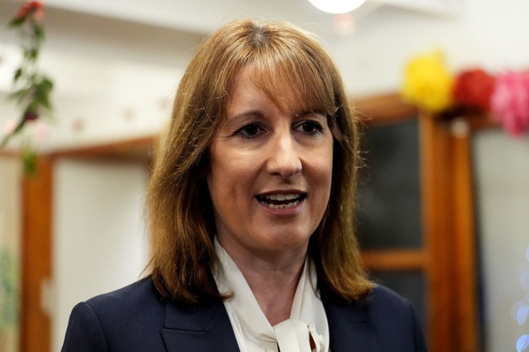 Rachel Reeves delivering a speech at a business conference, highlighting economic strategies and engaging with an audience.