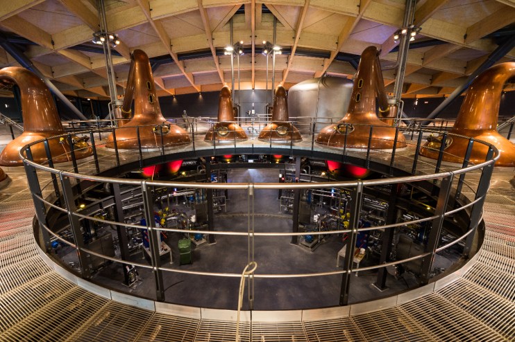 The Macallan Distillery in scenic Scottish landscape, showcasing its architecture and surrounding natural beauty.