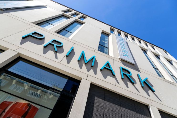 Primark storefront with shoppers entering and exiting, showcasing the latest fashion trends and bustling retail activity.