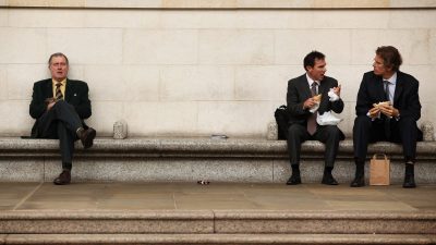 Businessman eating lunch outdoors in Canada financial district