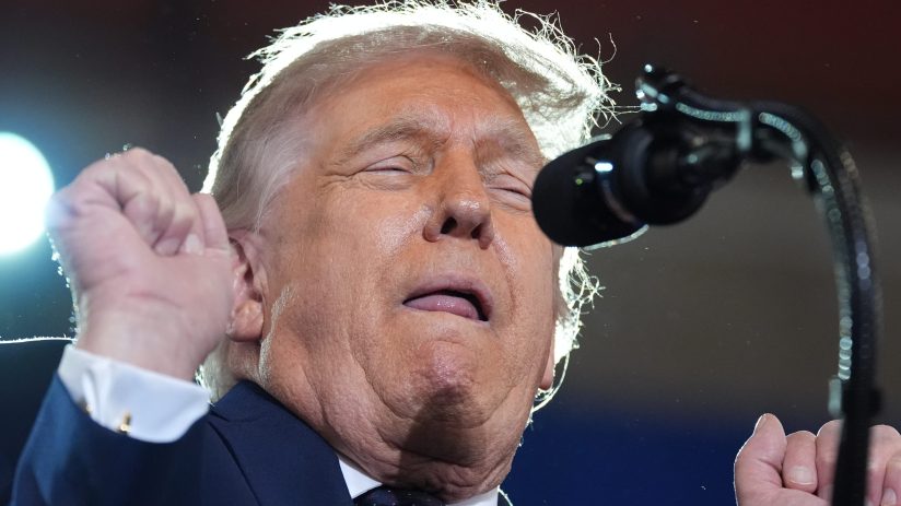 Donald Trump discussing the Iran nuclear deal, standing at a podium with the American flag in the background