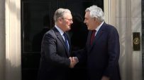 Gordon Brown and Keir Starmer engaged in discussion at a public event, emphasizing leadership and political strategy.