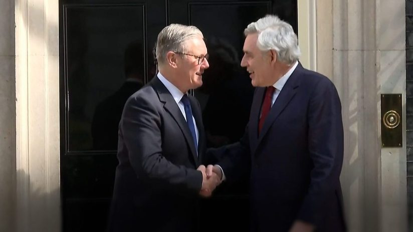 Gordon Brown and Keir Starmer engaged in discussion at a public event, emphasizing leadership and political strategy.