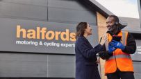 Halfords store exterior showcasing automotive and cycling products, highlighting retail branding and customer access points