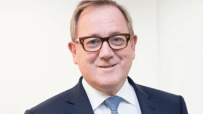 Mark Dixon, CEO of IWG, in a business setting discussing flexible workspace solutions and future industry trends.