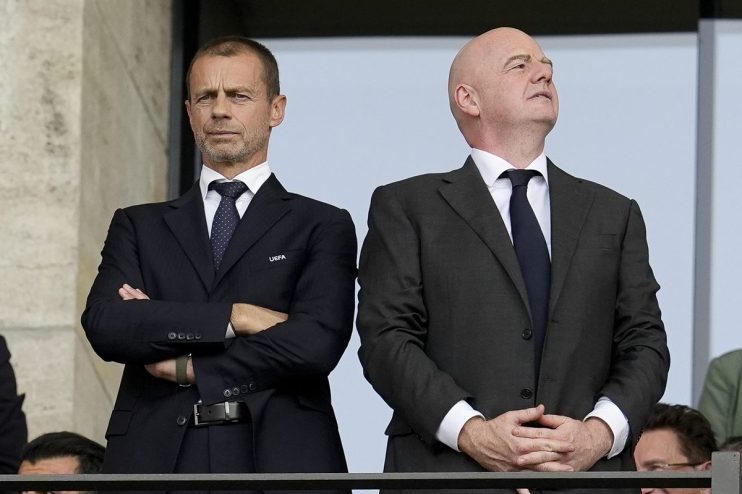 Aleksander Čeferin, UEFA President, and Gianni Infantino, FIFA President, observing from a stadium box.