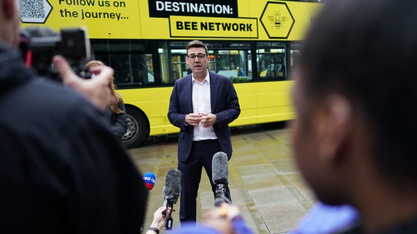 Andy Burnham discussing Manchesters Bee Network public transport initiative at a city council event.