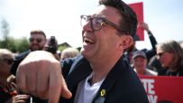 Andy Burnham laughing outdoors in a candid moment, May 2026, capturing a lighthearted political event atmosphere.