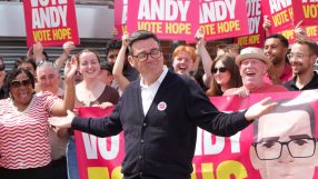Andy Burnham supporters rallying with banners and signs at a political event, showcasing enthusiasm and solidarity