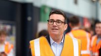 Andy Burnham, Mayor of Greater Manchester, in a high-vis vest at a technical education event.