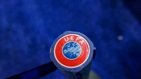 Close-up of a blue and red UEFA logo on a sports equipment handle against a blurred blue background