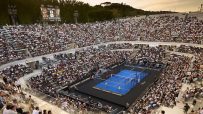 Padel match in a large, crowded stadium in Rome, Italy, with a scoreboard displaying scores.