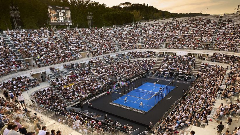 Padel match in a large, crowded stadium in Rome, Italy, with a scoreboard displaying scores.