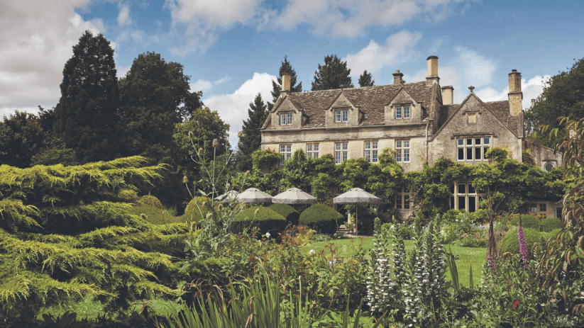 Elegant UK country house with lush gardens, perfect for a summer staycation or holiday retreat.