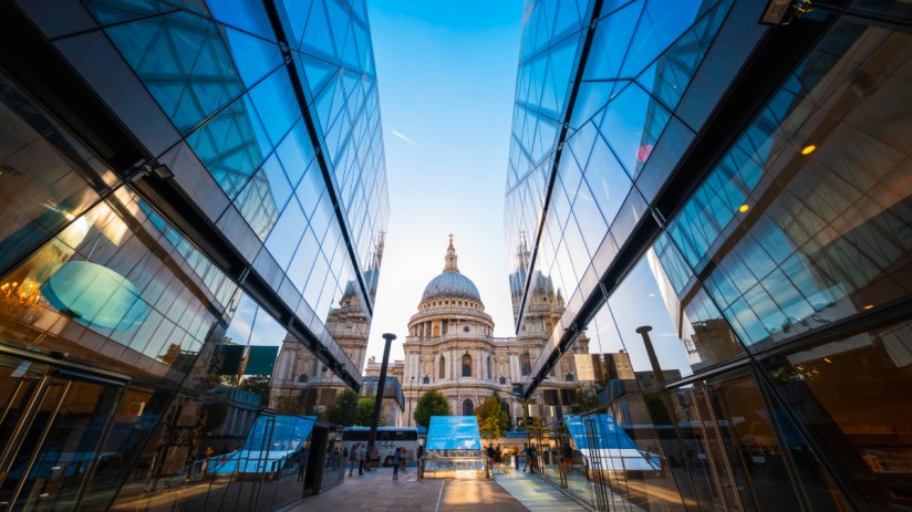 St Pauls Cathedral in London, framed by modern glass buildings under a clear sky, near Cavendishs base