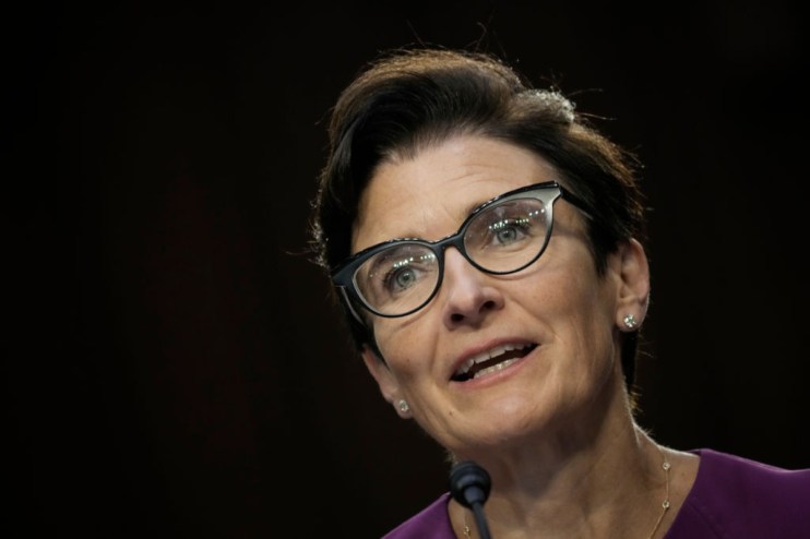 Jane Fraser, Citi CEO, speaking at a podium with a microphone, wearing glasses and a purple top.