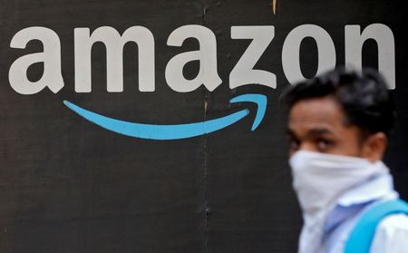 A man walks past an Amazon logo outside the company's collection point in Mumbai